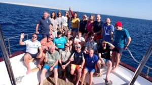 Group photo of divers at the bow of the Emperor Superior liveaboard