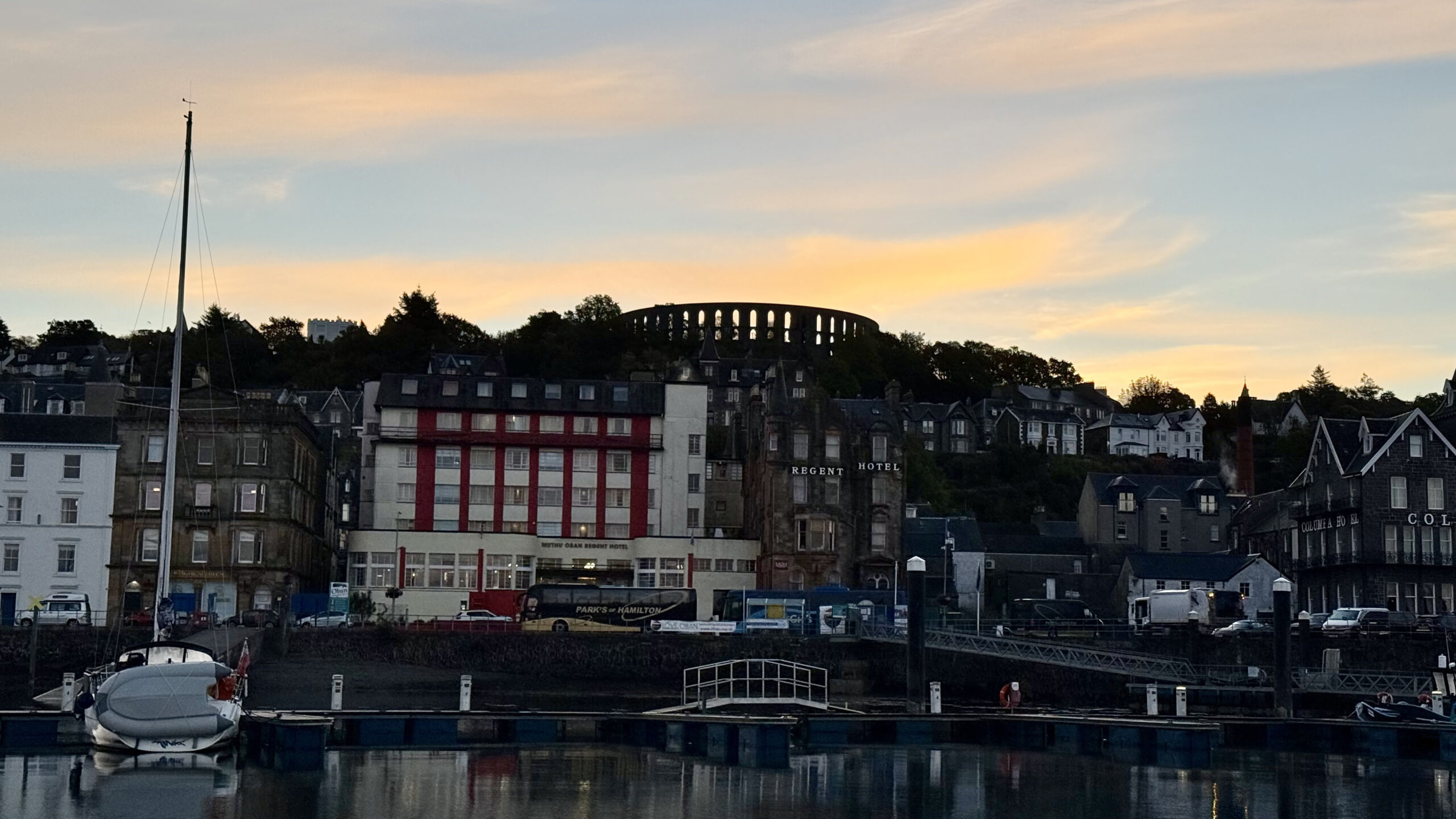 Seafront buildings and sunset sky.