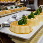 4 beige desserts on serving plate