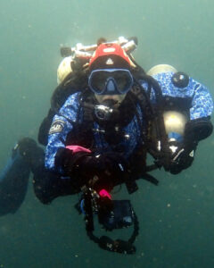 Technical diver midwater with twinset, stage and camera