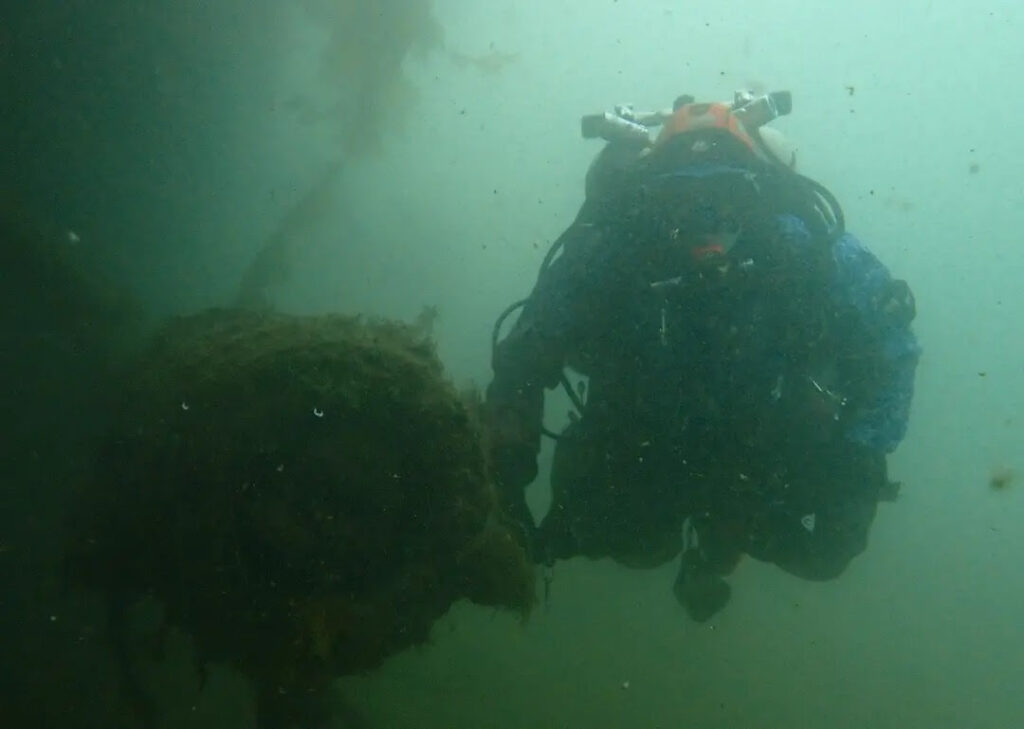 Diver next to ship's gun