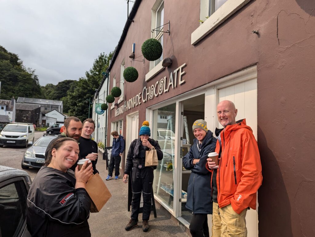 Six divers stood outside Tobermory Handmade Chocolate enojying their purchases