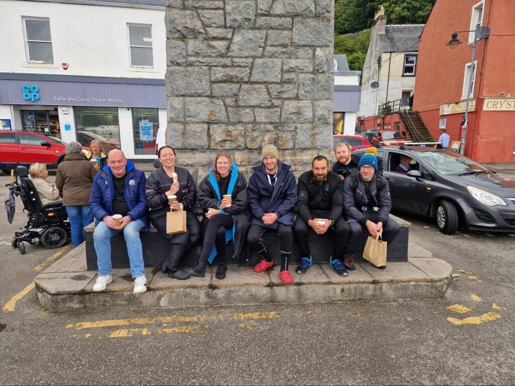 Seven divers sat outside in Tobermory